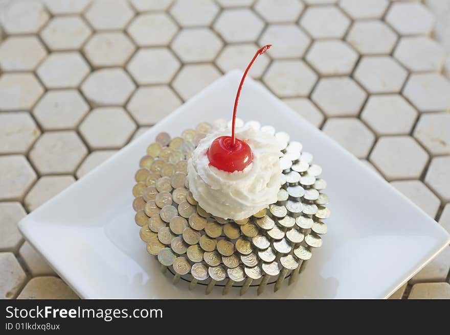 Cupcake constructed of nailgun coil,whipped cream, and maraschino cherry. Cupcake constructed of nailgun coil,whipped cream, and maraschino cherry