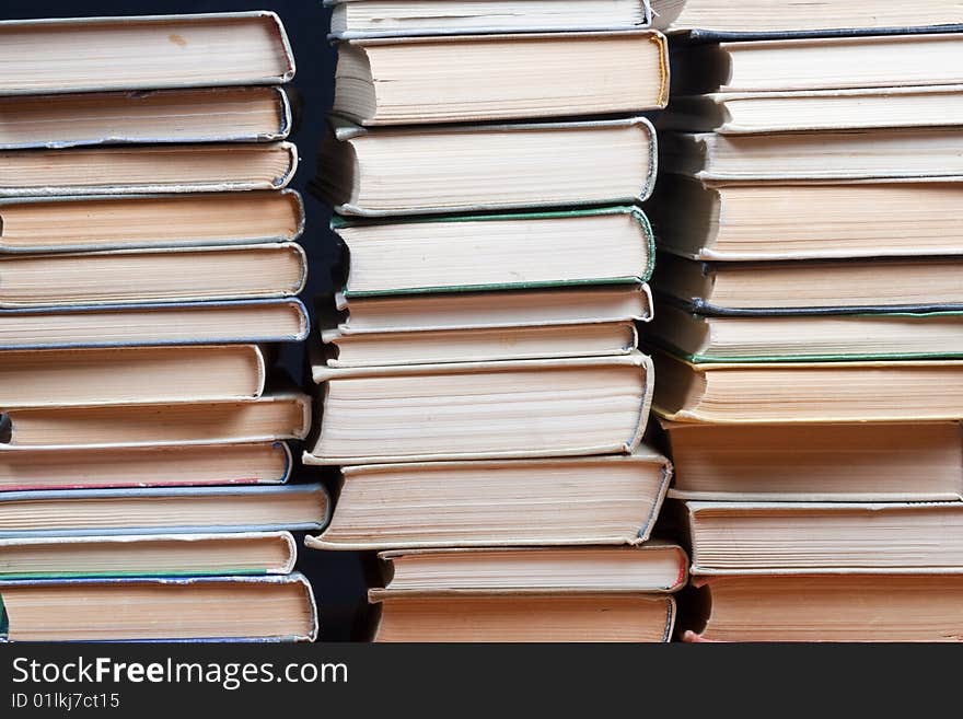 Three piles old books on black background. Three piles old books on black background