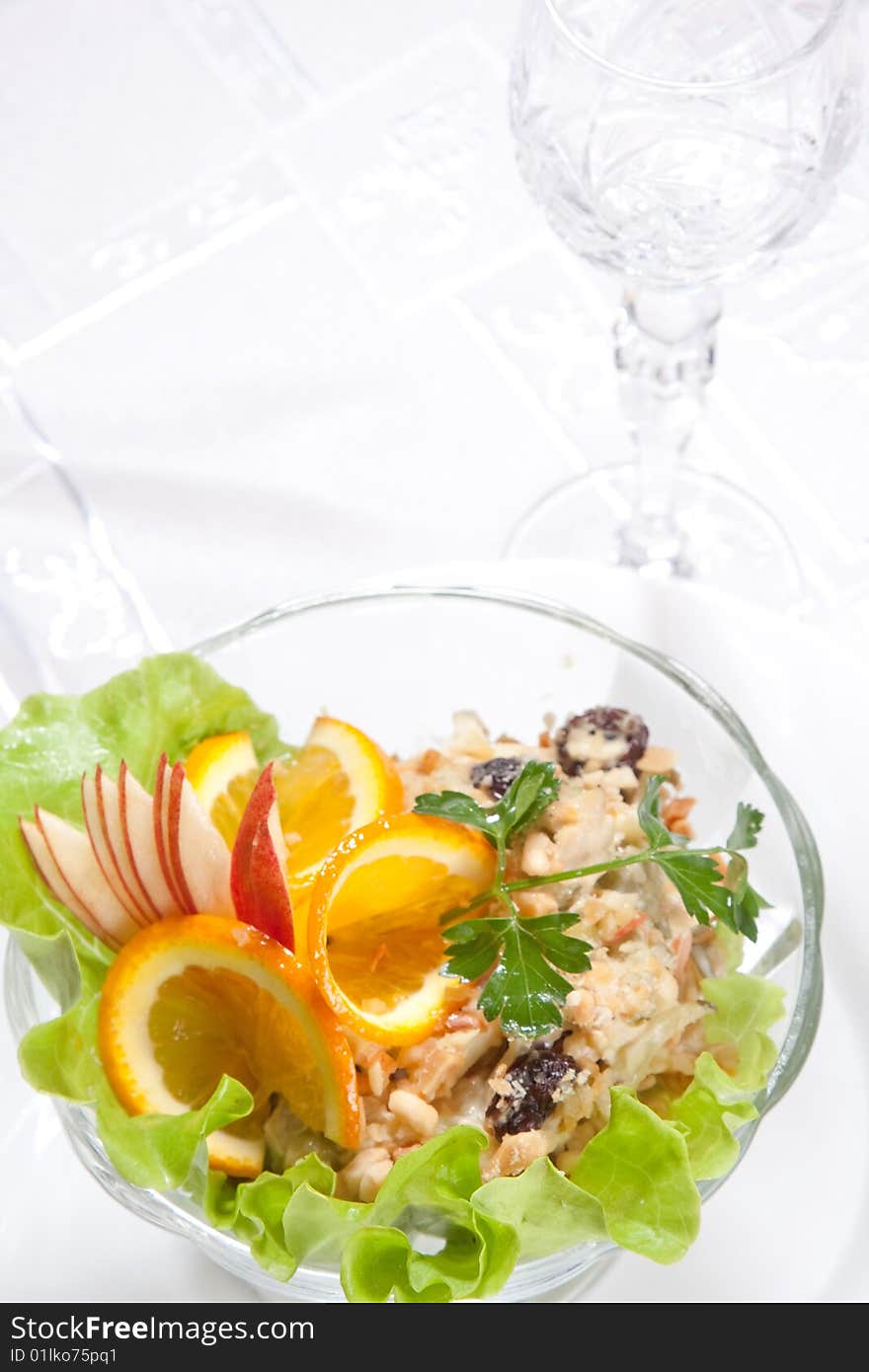 Goblet and salad with apples and nuts