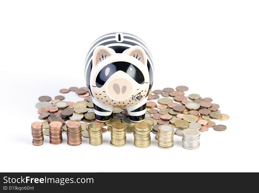 Closeup of a piggy bank sitting on euro coins