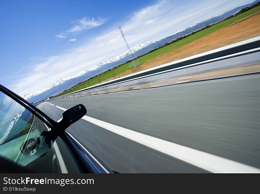 Driving at high speed under blue sky. Angled point of view. Driving at high speed under blue sky. Angled point of view