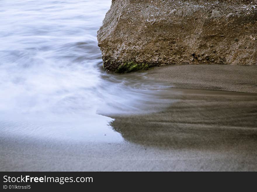 Long exposed water fighting with rock.