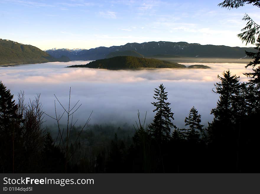 A view from Burnaby Mountain towards the Burrard Inlet and Indian Arm covered in clouds near Vancouver, Canada. A view from Burnaby Mountain towards the Burrard Inlet and Indian Arm covered in clouds near Vancouver, Canada.