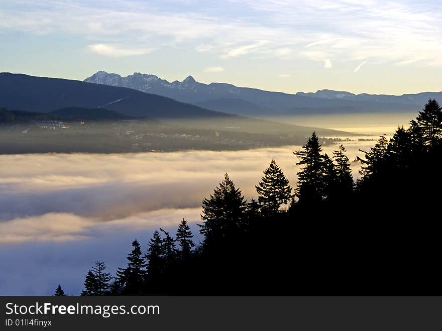 A view from Burnaby Mountain towards the Burrard Inlet and Indian Arm covered in clouds near Vancouver, Canada. A view from Burnaby Mountain towards the Burrard Inlet and Indian Arm covered in clouds near Vancouver, Canada.