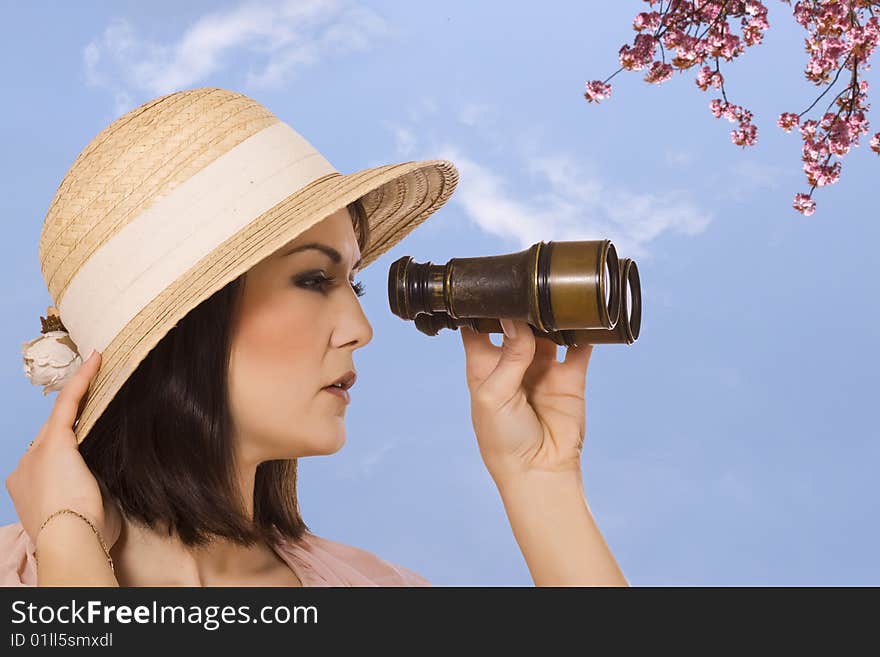 Young woman looking through binocular. isolated on white background