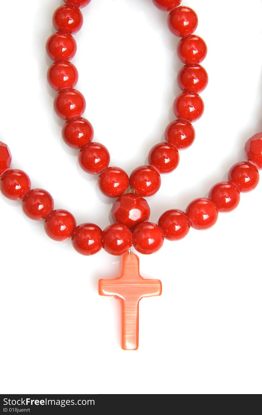 Red coral beads on a white background