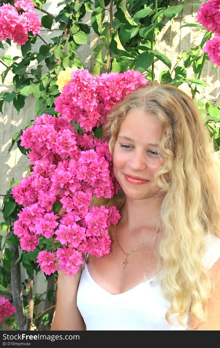 Pretty blond freckled girl with pink flowers. Pretty blond freckled girl with pink flowers.