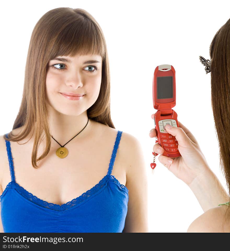 Two teenage girls photographing on mobile phone. Isolated on white background