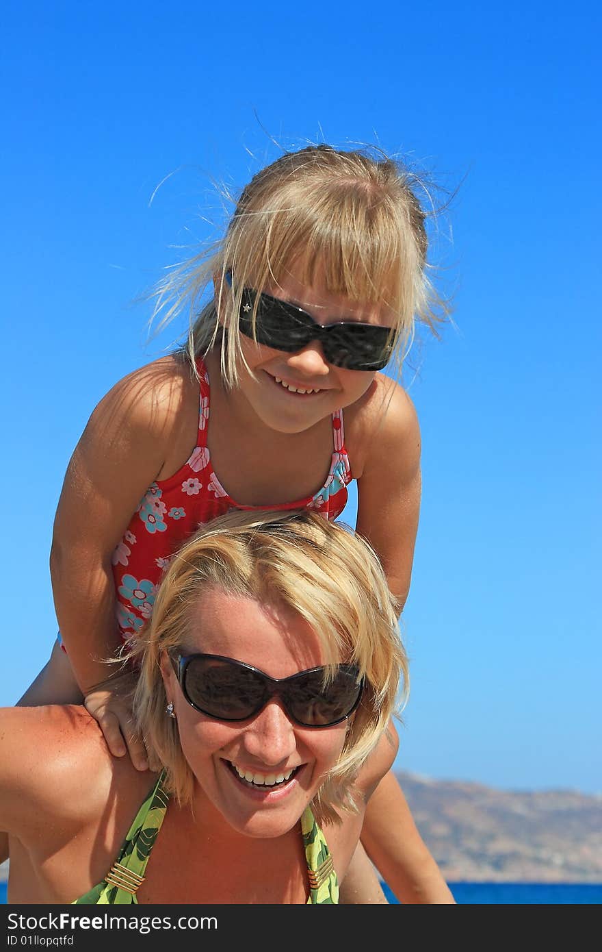 Happy mum with a daughter have a rest on the sea