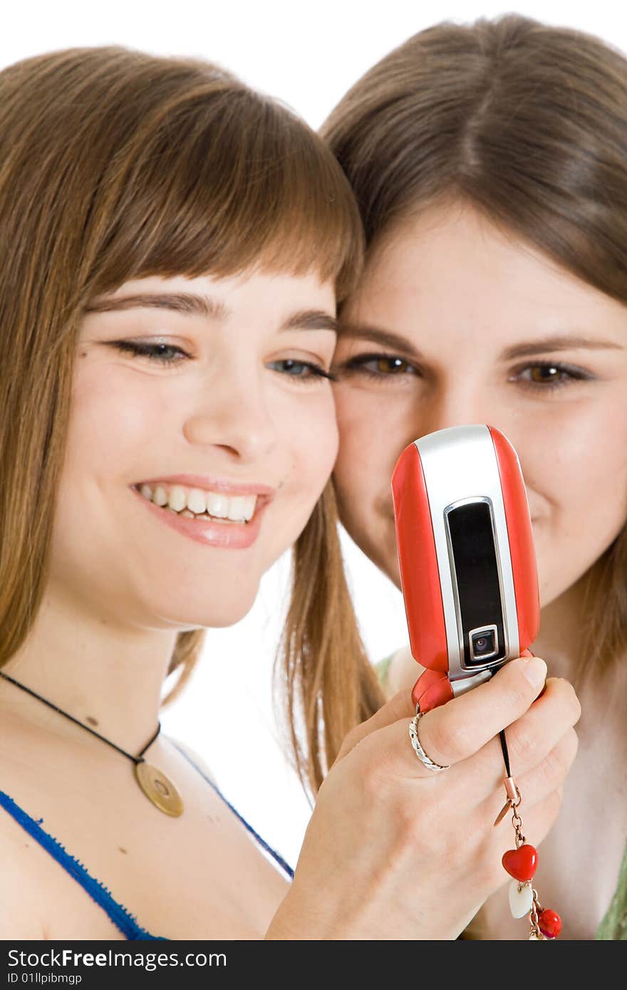 Two pretty girls reading SMS on mobile phone