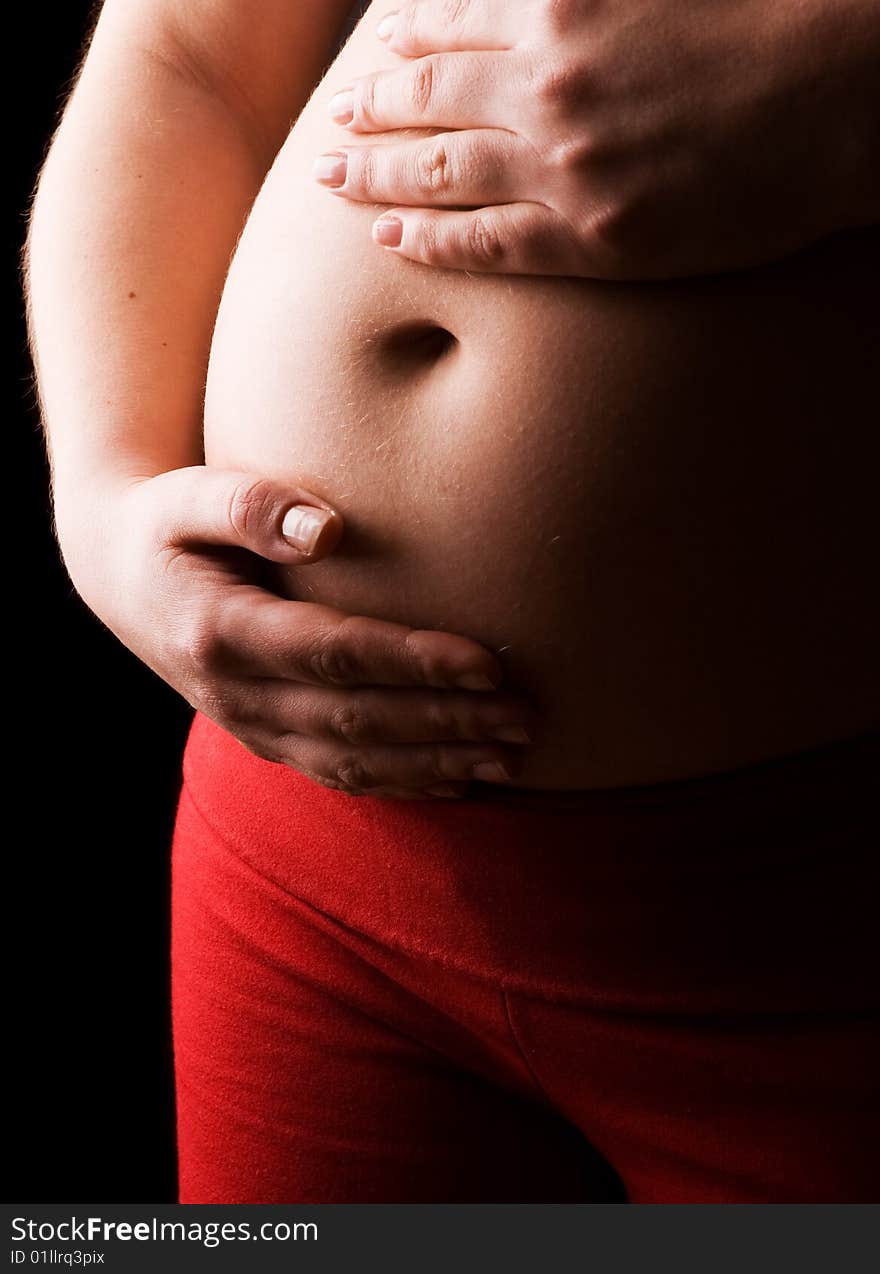 Young Pregnant Woman holding her Belly