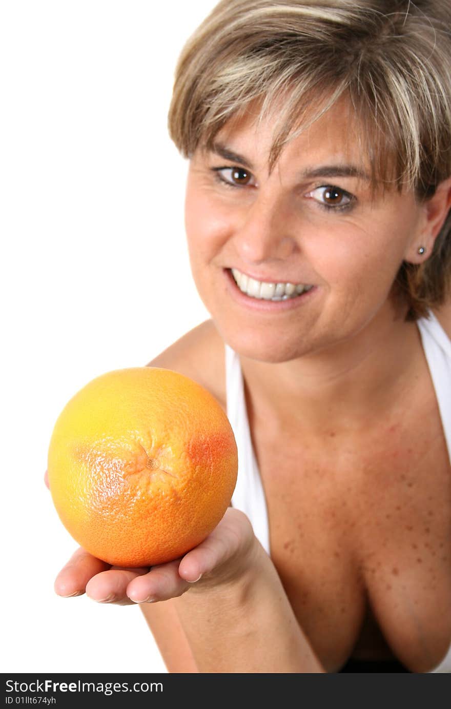 Beautiful mature female holding fruit.  FOCUS ON ORANGE. Beautiful mature female holding fruit.  FOCUS ON ORANGE