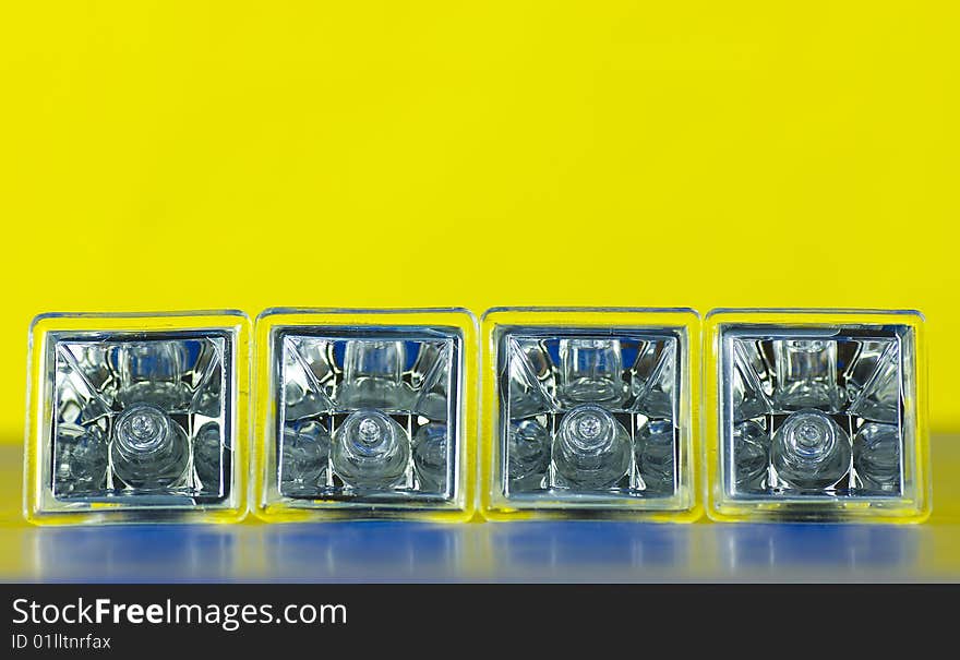 Four decorative atypical square halogen light bulbs laying on side isolated on gradient background. Four decorative atypical square halogen light bulbs laying on side isolated on gradient background