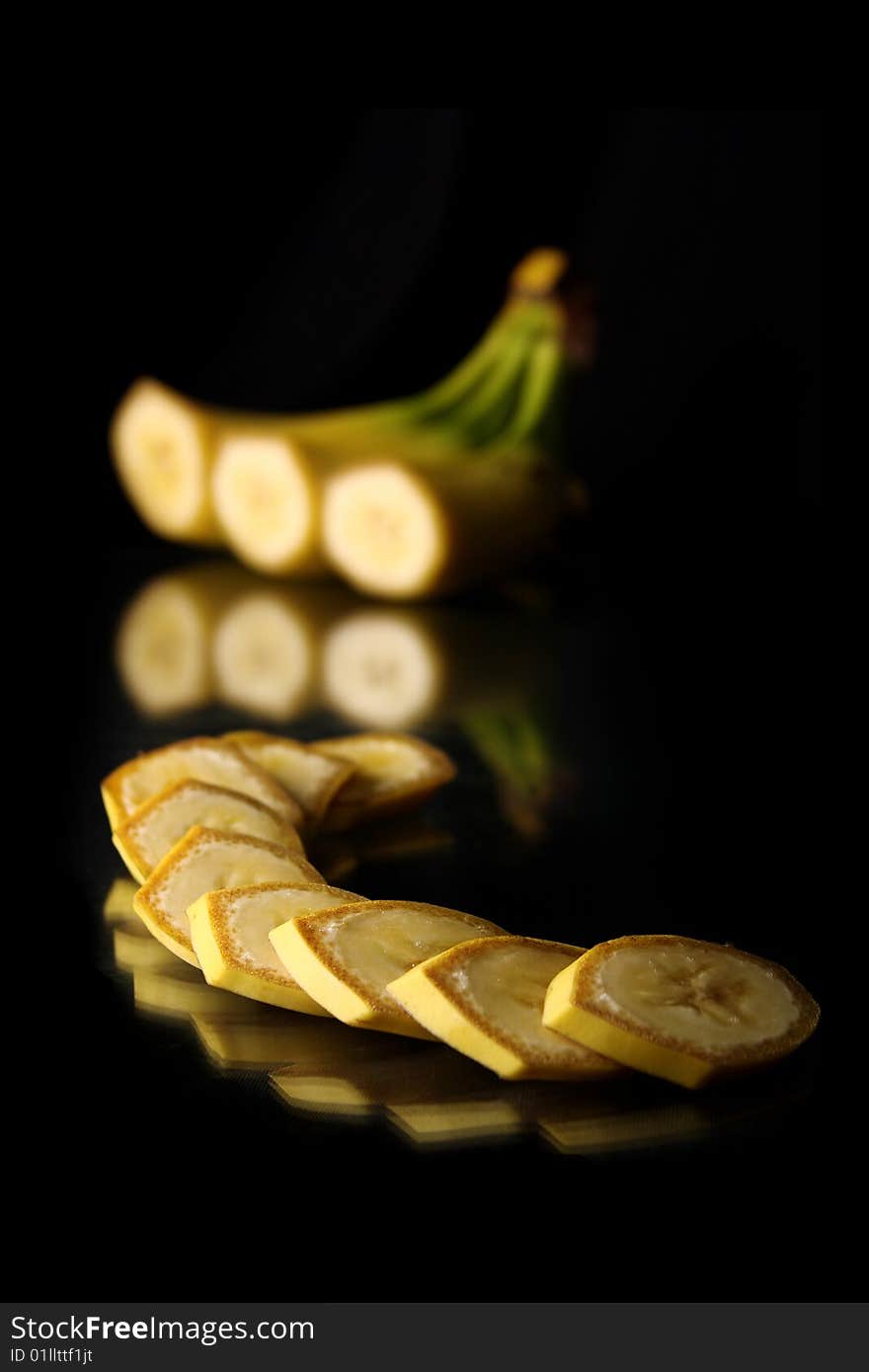 Still life mature cut bananas on black background with clipping path