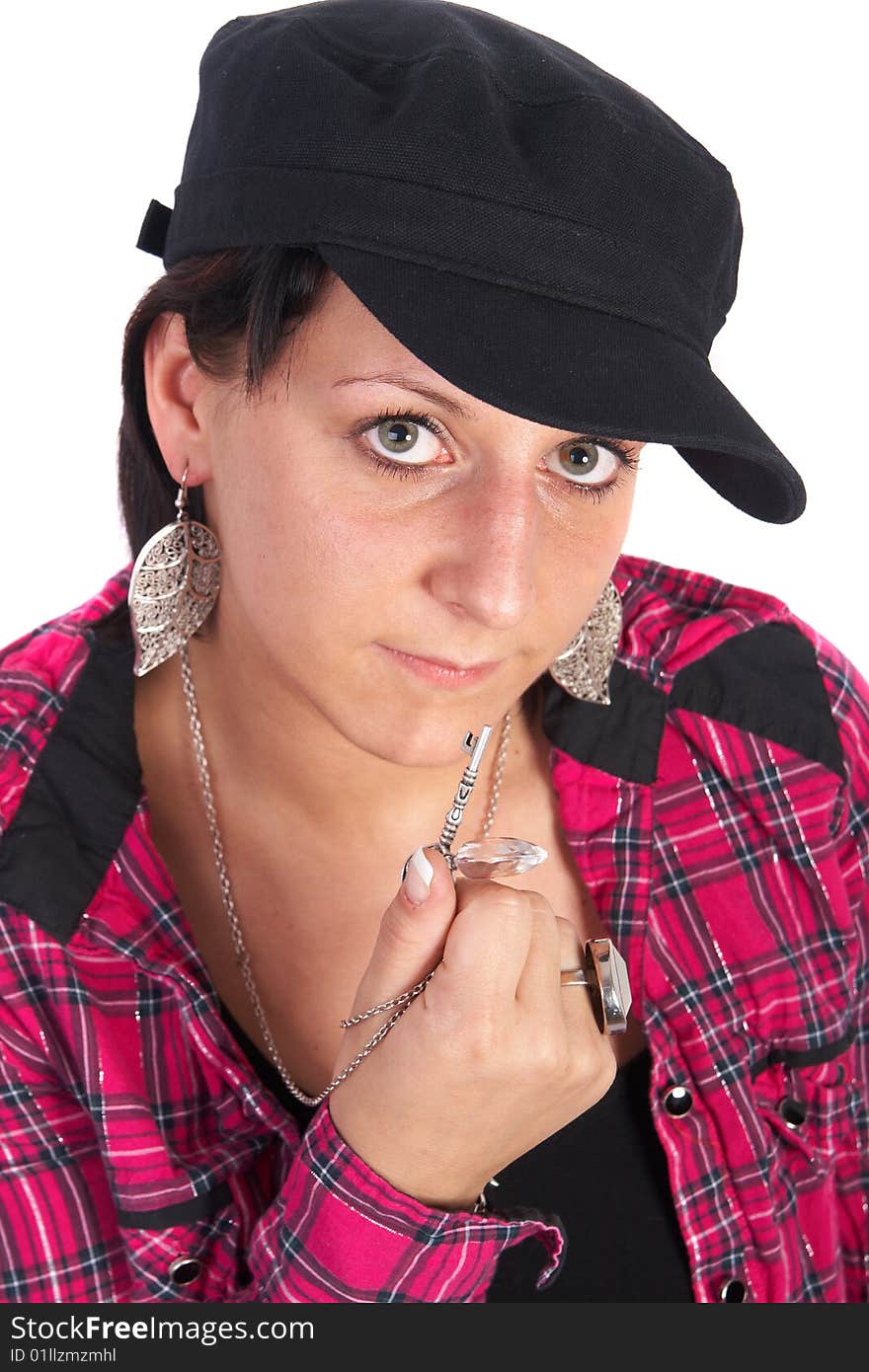 Portrait of a young woman wearing a pink shirt and ripped blue jeans. She is showing a key. Portrait of a young woman wearing a pink shirt and ripped blue jeans. She is showing a key.