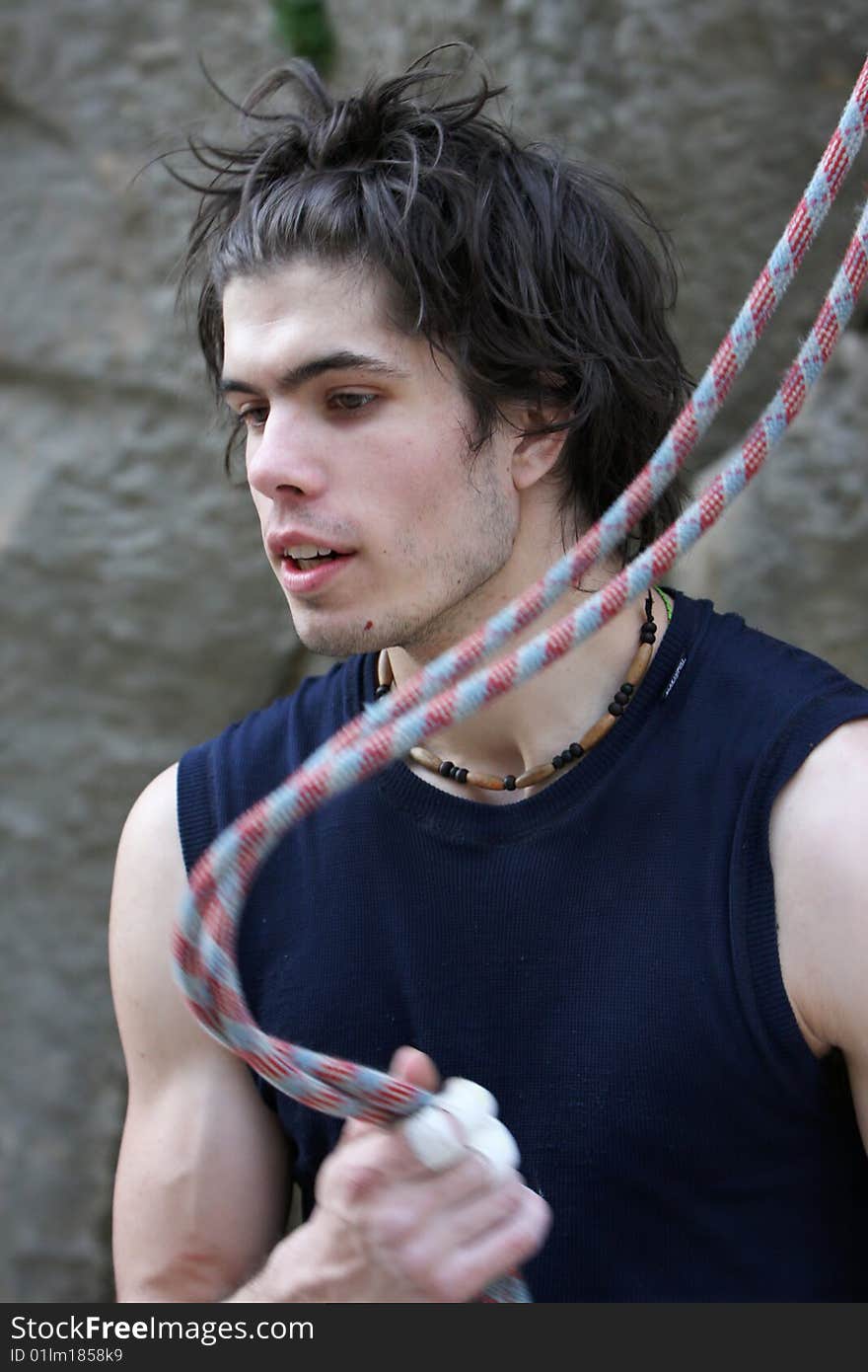 Young man holding climbing rope