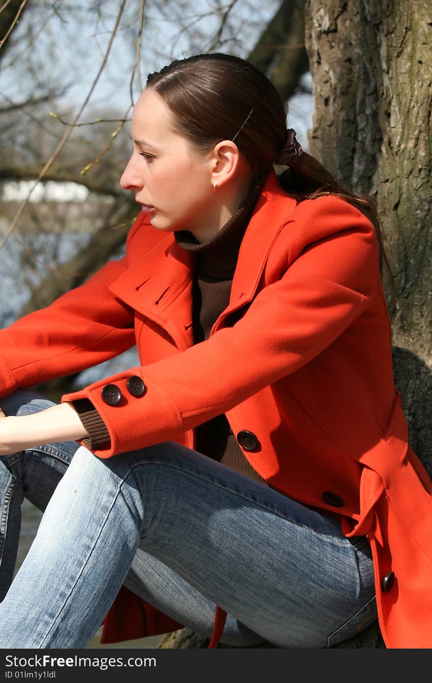 Woman sitting outdoor in a foul mood. Woman sitting outdoor in a foul mood