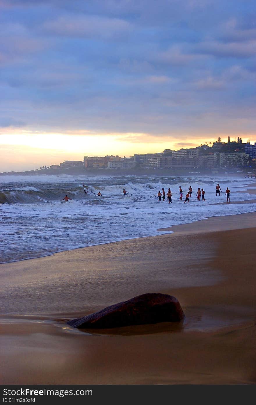 Sun bathers swimming in the sea befor sun set