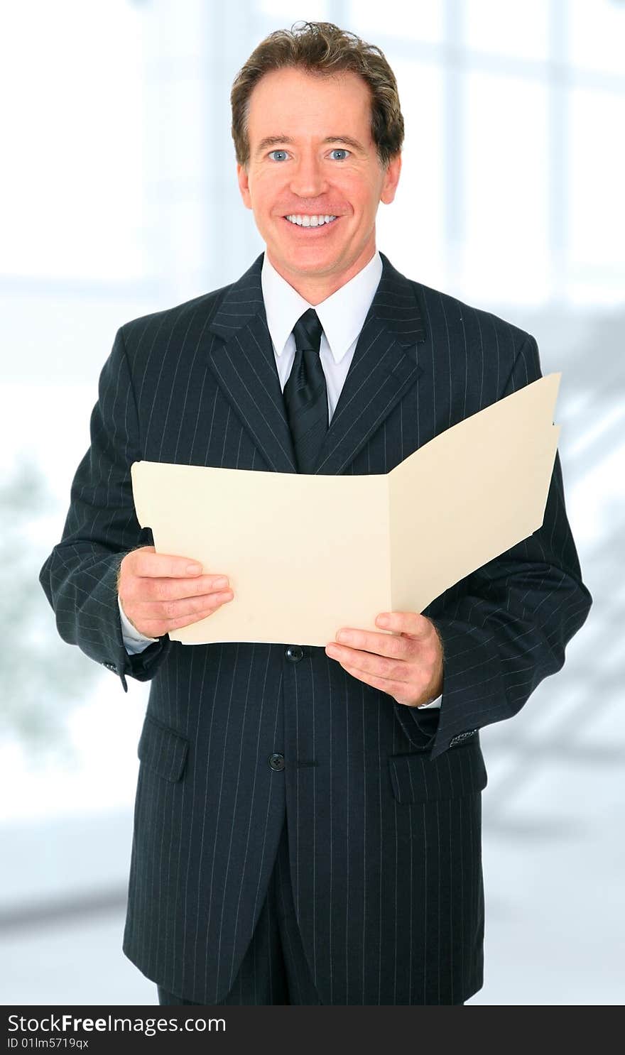 Smiling Senior Business Man Holding Folder