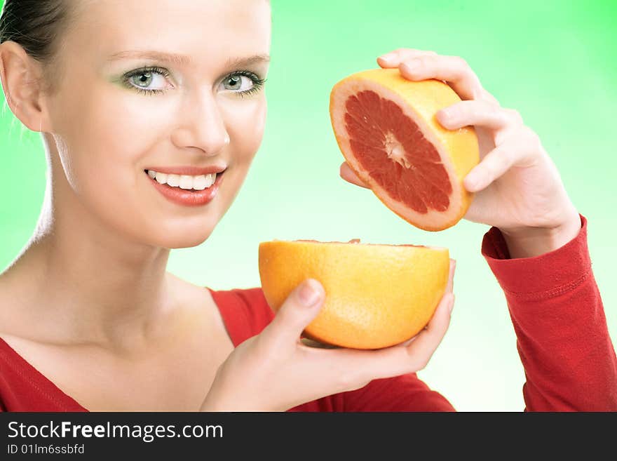 Young beauty woman with grapefruit on green background. Young beauty woman with grapefruit on green background