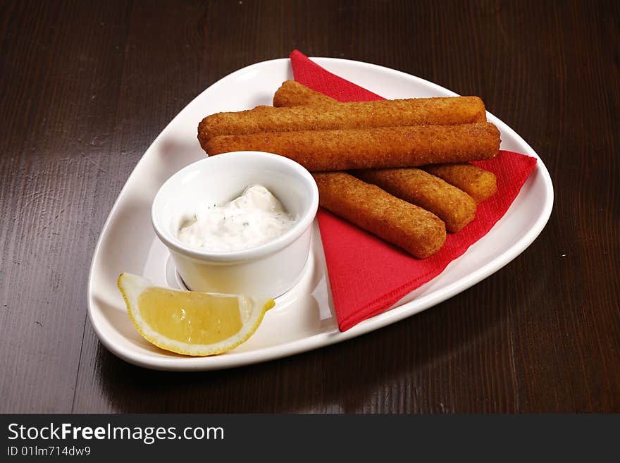 Roasted Cheese Sticks On White Plate