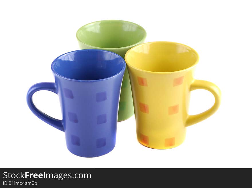 Colour cups for tea and coffee. A small white teapot. Colour cups for tea and coffee. A small white teapot.