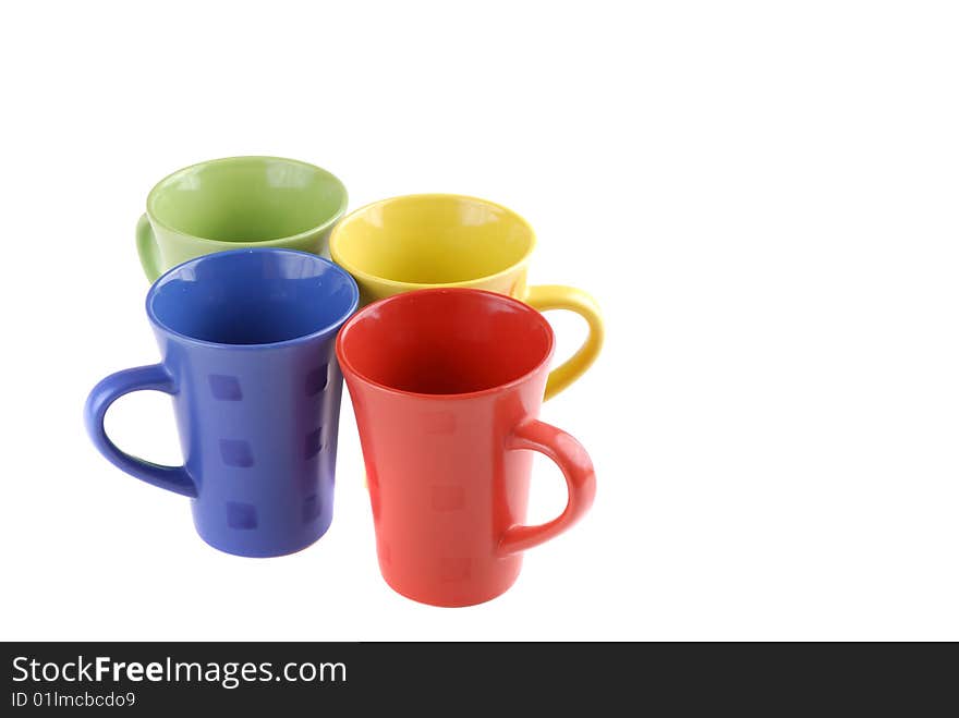 Colour cups for tea and coffee. A small white teapot. Colour cups for tea and coffee. A small white teapot.