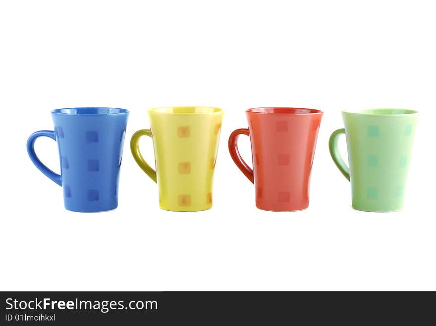 Colour cups for tea and coffee. A small white teapot. Colour cups for tea and coffee. A small white teapot.