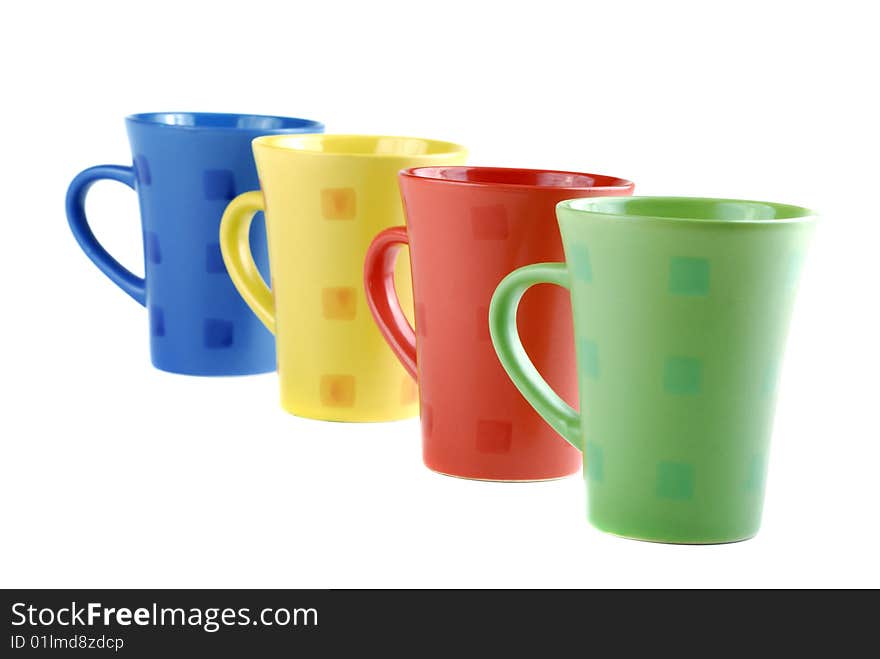 Colour cups for tea and coffee. A small white teapot. Colour cups for tea and coffee. A small white teapot.