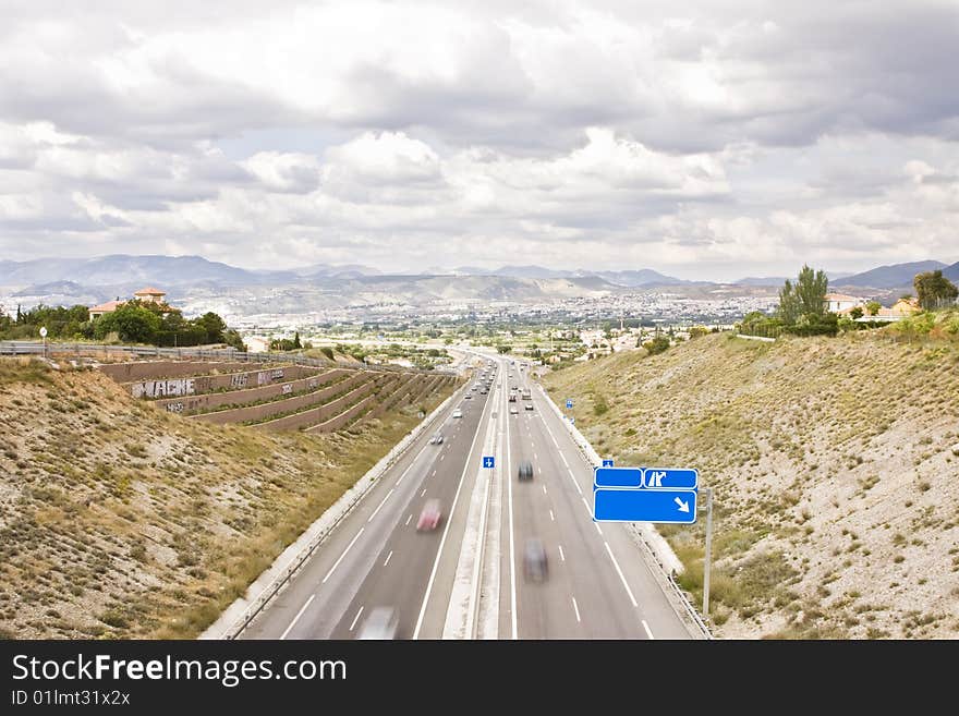 Highway to the city, blank blue sign in one side. Highway to the city, blank blue sign in one side.