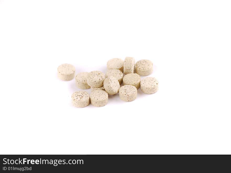 Tablets of various colour on a white background. Food additives.