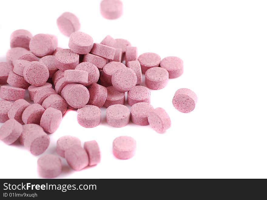 Tablets of various colour on a white background. Food additives.