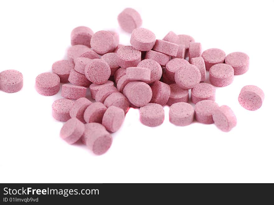 Tablets of various colour on a white background. Food additives.