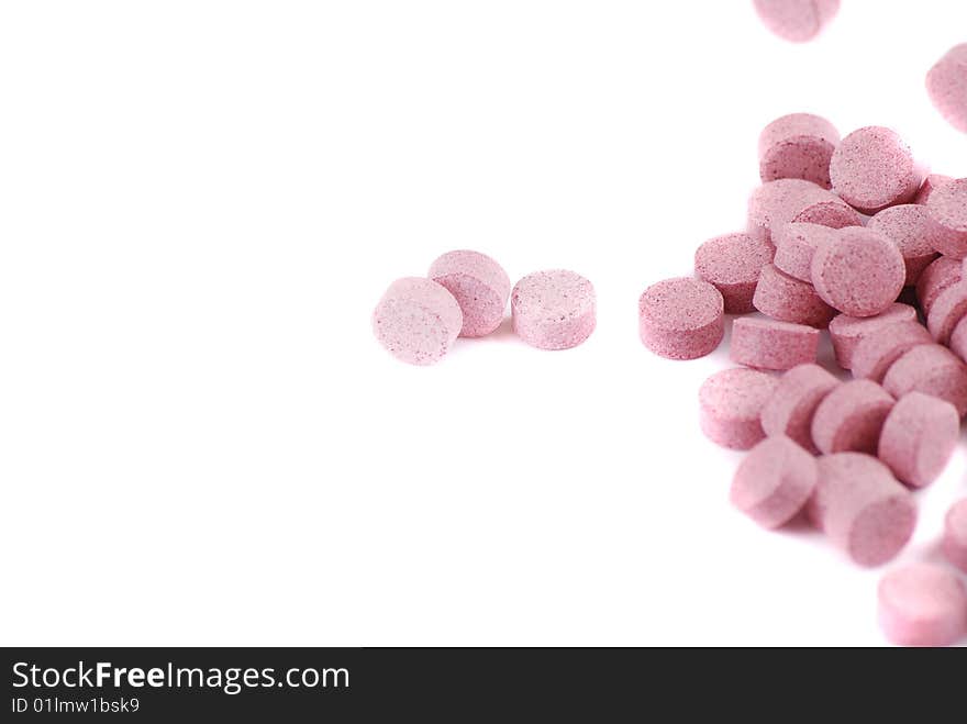 Tablets of various colour on a white background. Food additives.