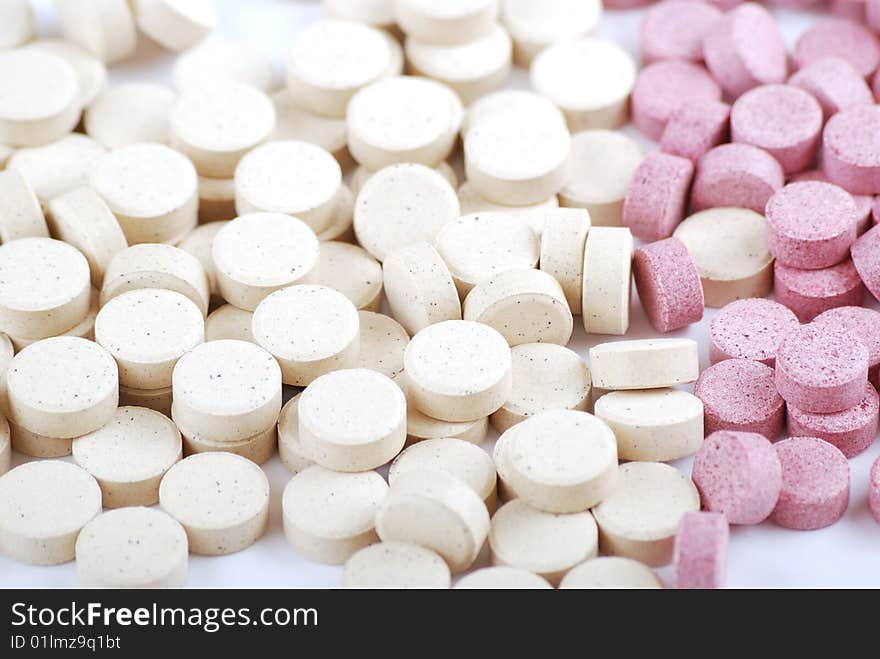 Tablets of various colour on a white background. Food additives.