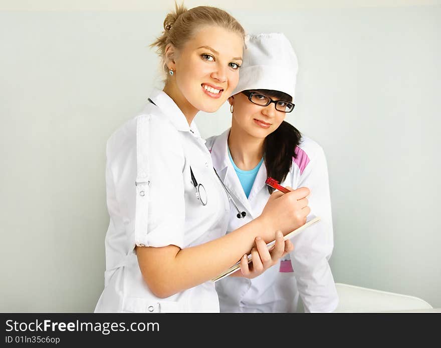 Portrait of a young doctor with her assistant in the office