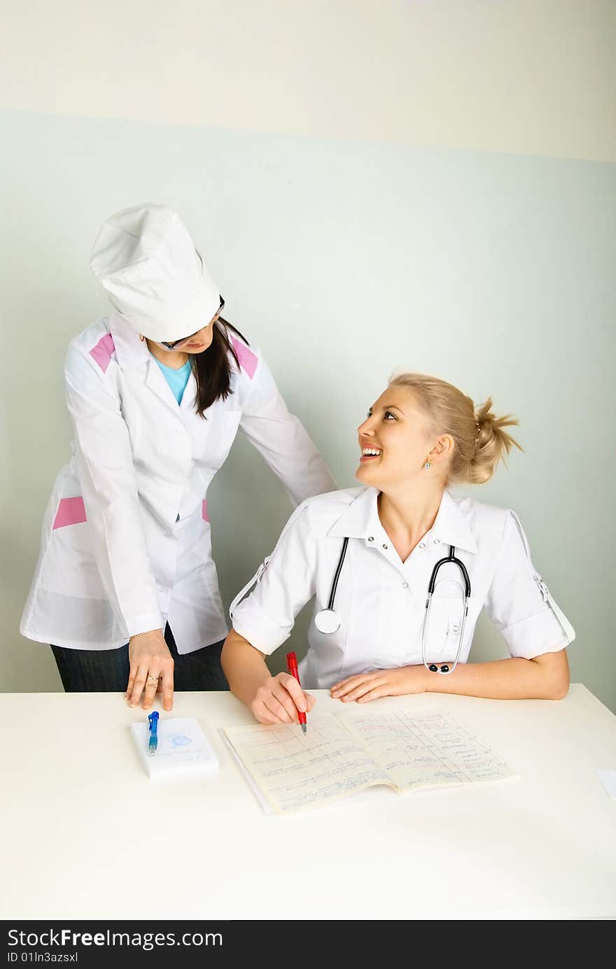 Young doctor with her assistant in the office