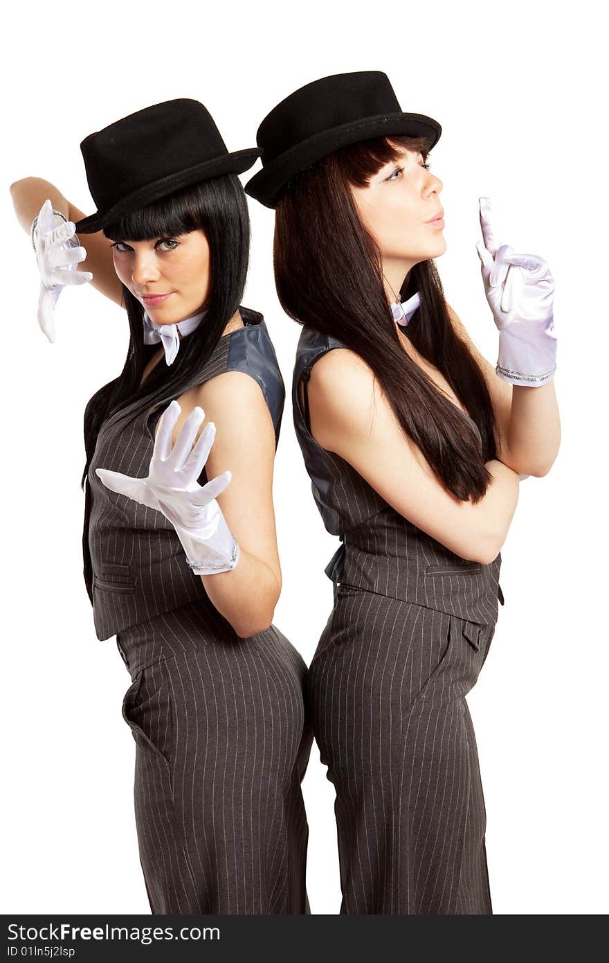 Two brunette woman in striped suits and hats. Two brunette woman in striped suits and hats