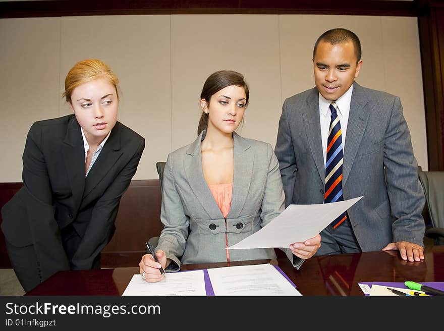 Team members reading a report in the board room. Team members reading a report in the board room