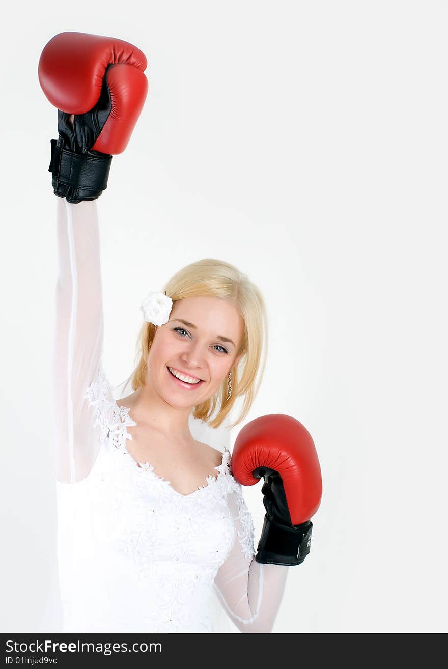 Bride wearing boxing gloves with one arm up