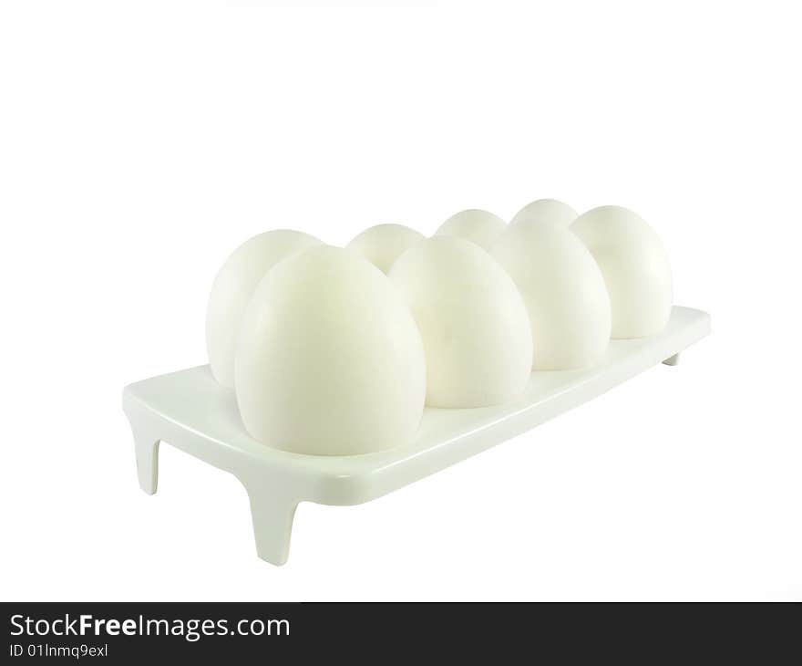 Eight white eggs on a support