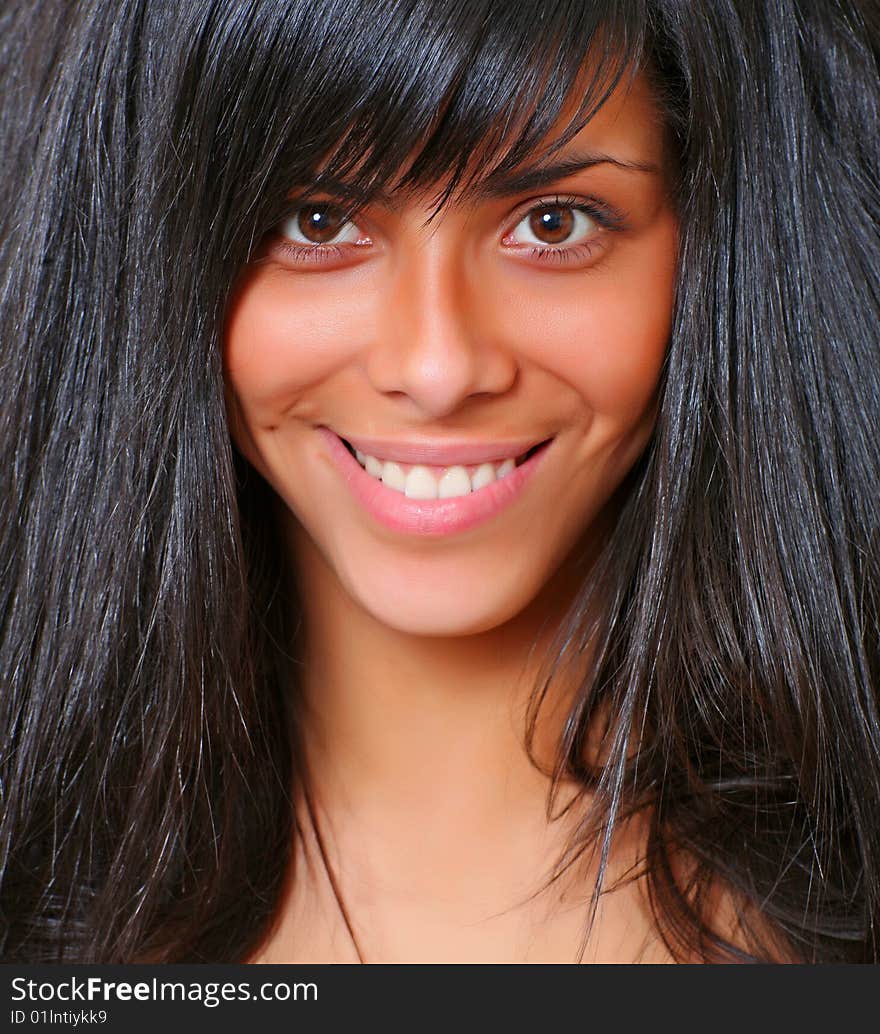 Portrait of the beautiful young woman with magnificent hair and with an open smile, please see some of my other parts of a body images: