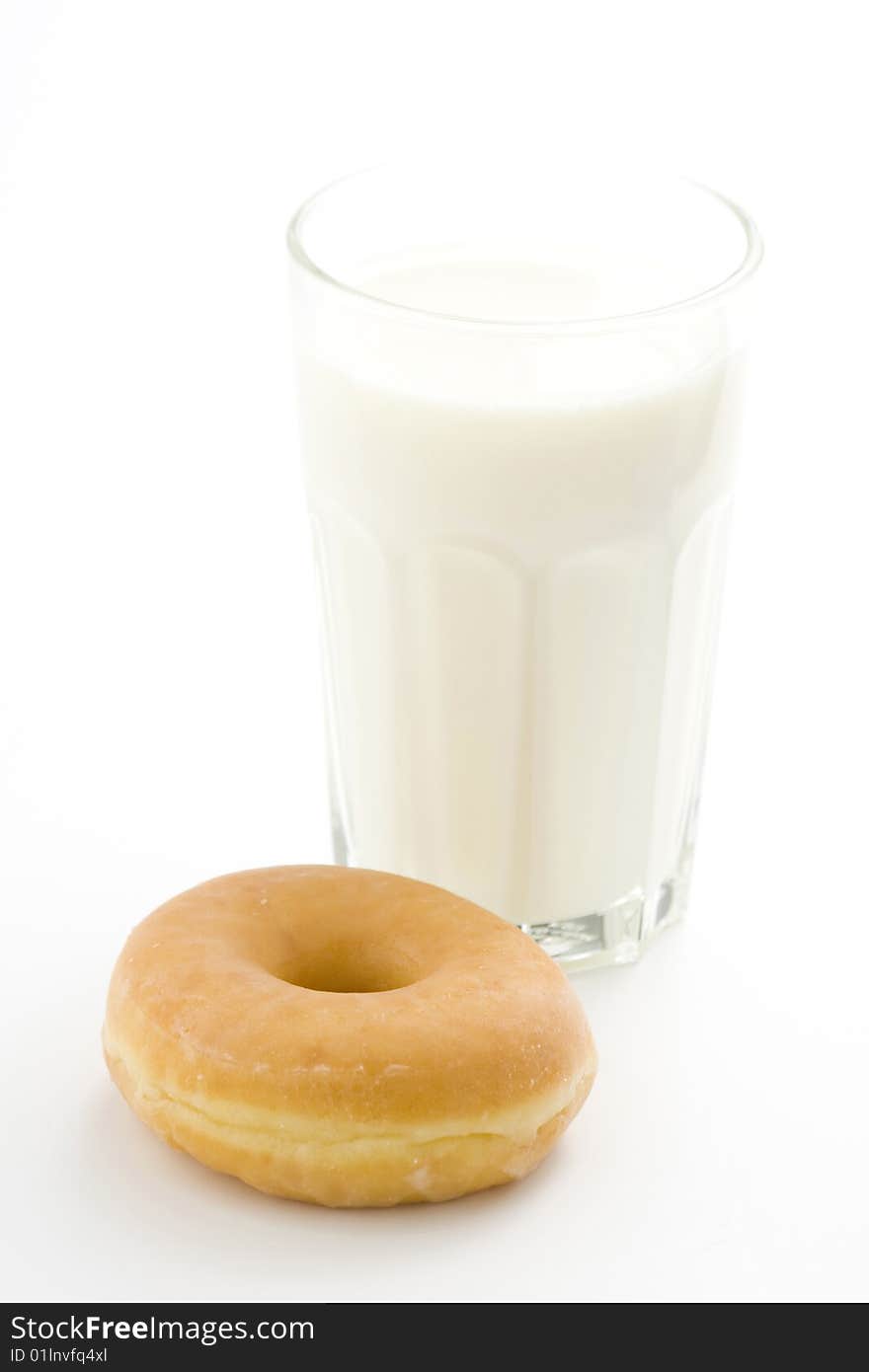 Breakfast glass of chocolate milk and donut isolated