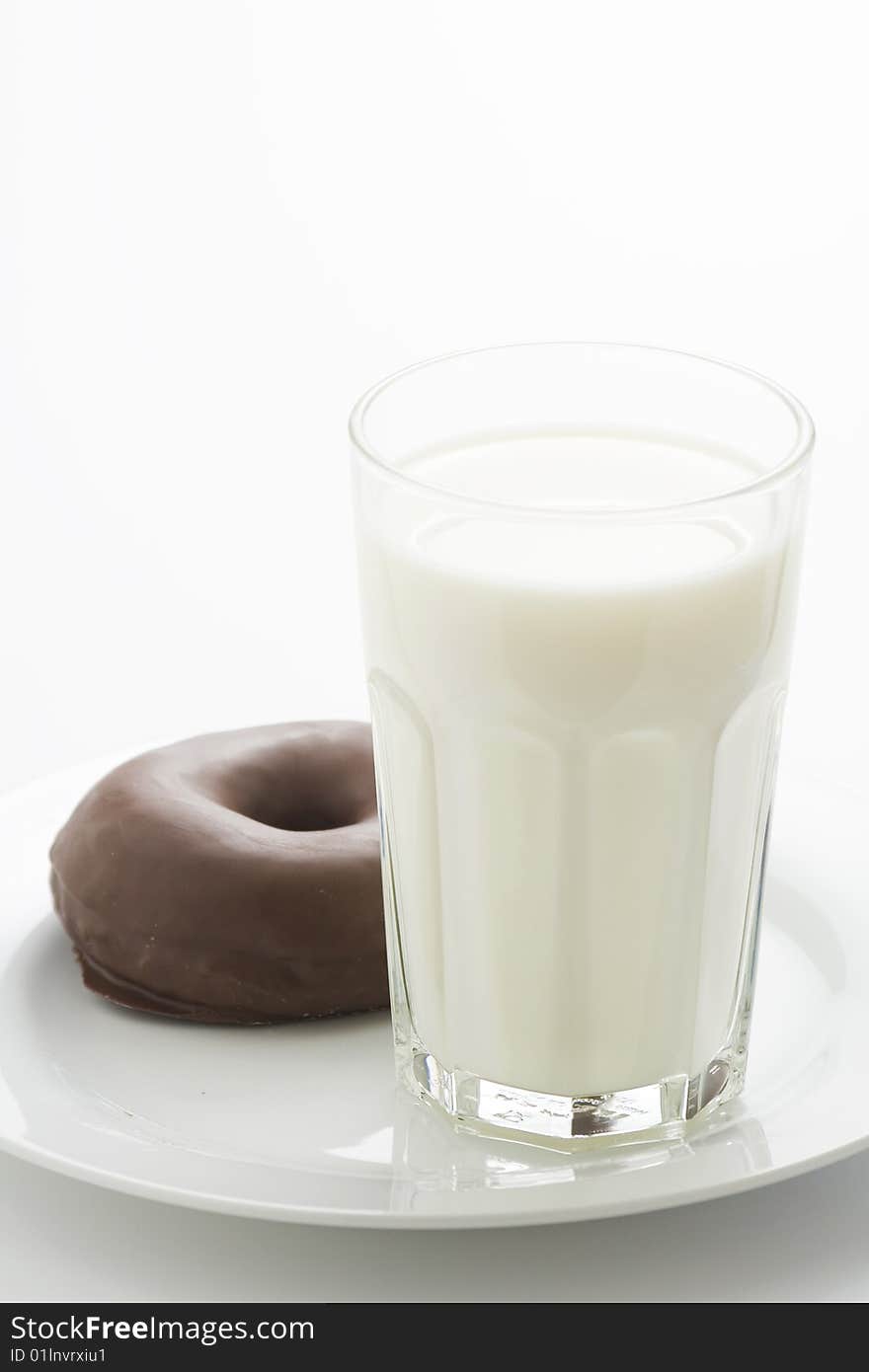 Breakfast glass of chocolate milk and donut isolated