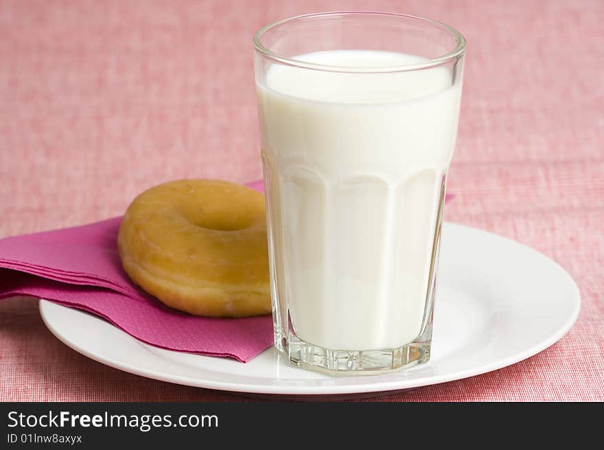 Breakfast glass of chocolate milk and donut isolated