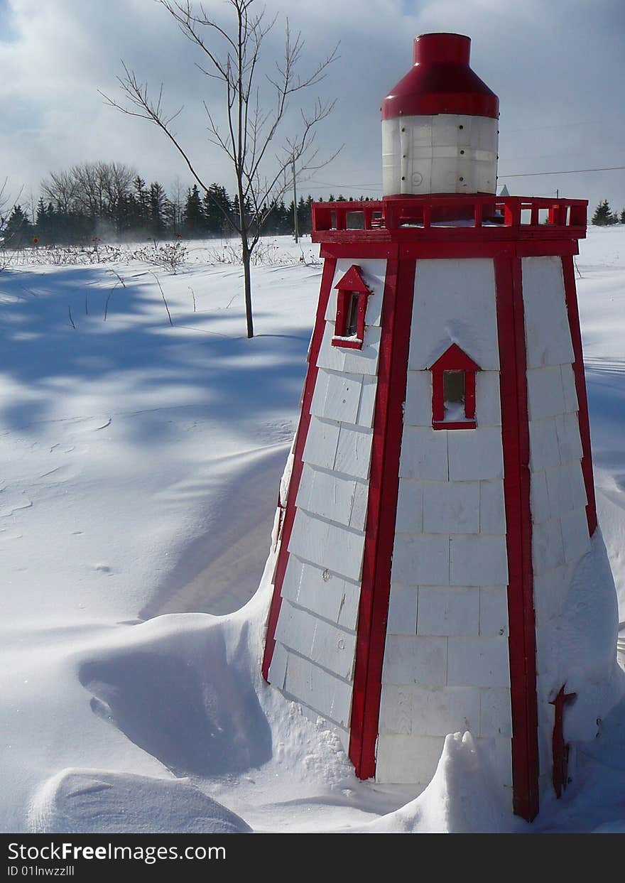 A home made lighthouse sits in the snow