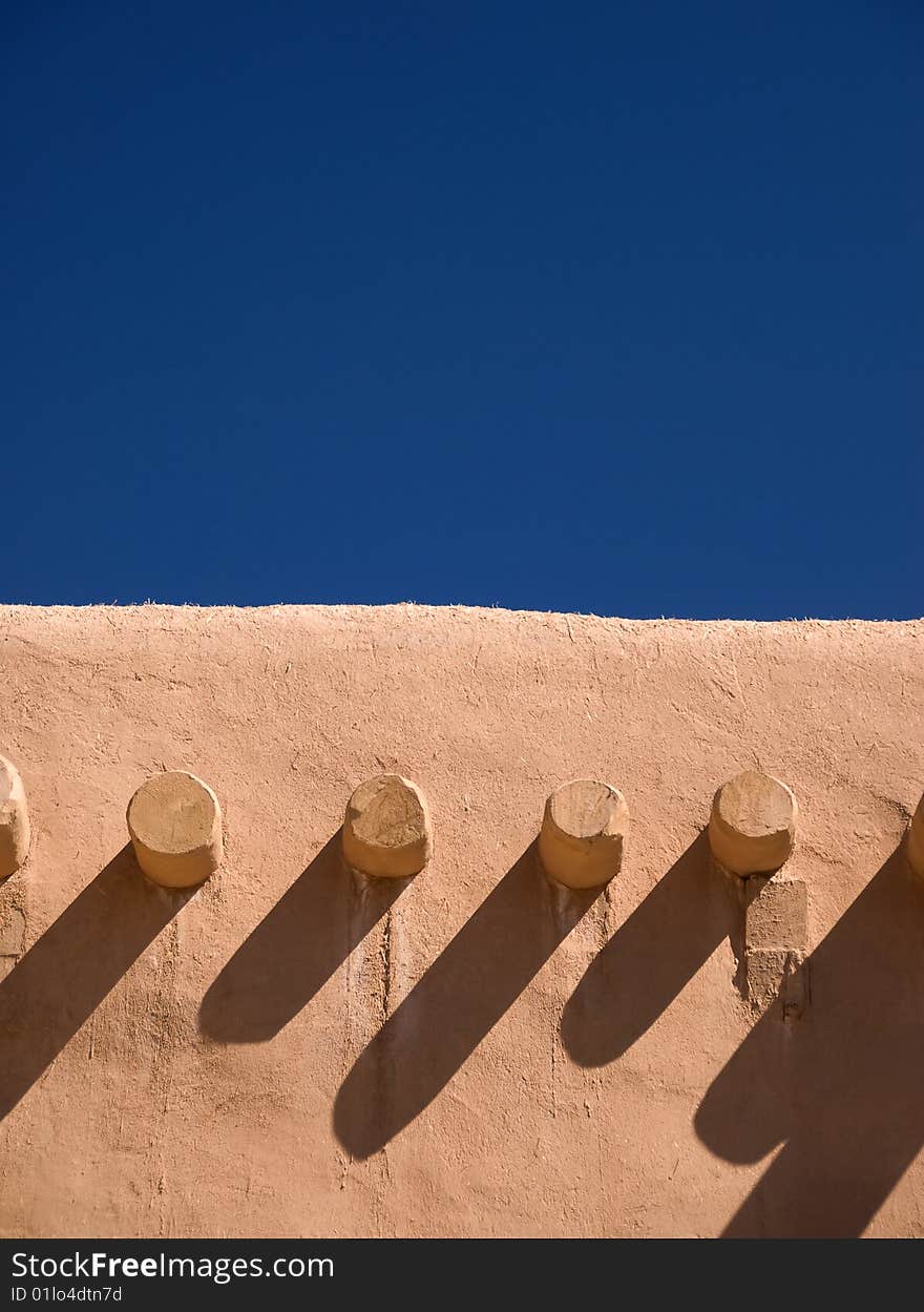 Adobe building roof view with blue sky behind for copyspace. Adobe building roof view with blue sky behind for copyspace