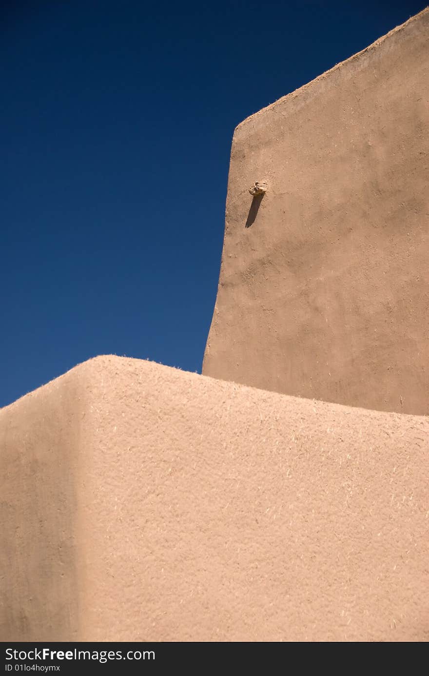 Adobe building roof view with blue sky behind for copyspace. Adobe building roof view with blue sky behind for copyspace