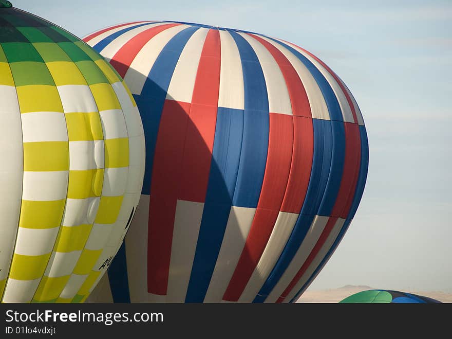 Two hot air balloons with a blue sky background