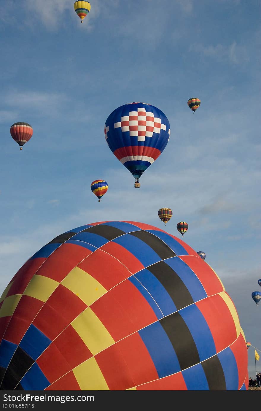 Two main hot air balloons with a blue sky background